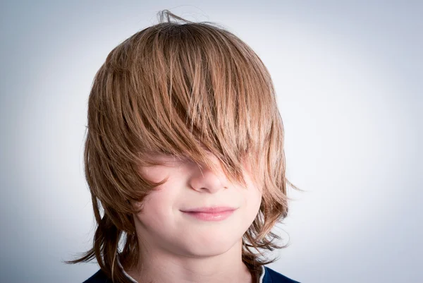 Child with long hair and covered eyes — Stock Photo, Image
