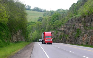 Red Semi Truck On Historic Route 6 clipart