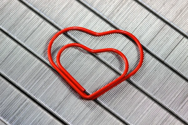 Red paper clip in heart shape — Stock Photo, Image