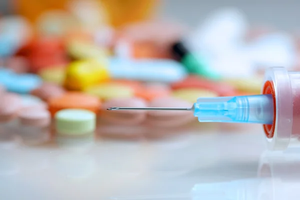 Syringe and colorful medicines — Stock Photo, Image