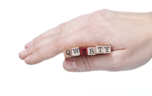 Vrouwelijke hand met qwerty leeters cobination — Stockfoto