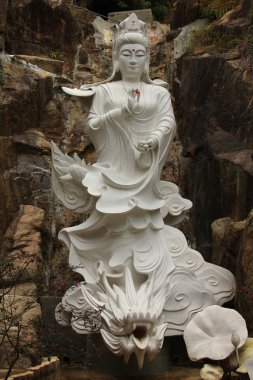 Statue of the goddess standing over the dragon at the Ten Thousand Buddhas Monastery clipart