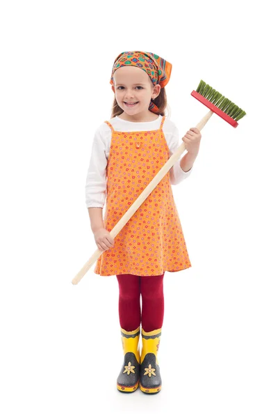 Meisje met broom en rubber laarzen — Stockfoto