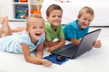 Happy kids with laptop computer clipart