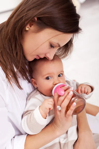 Baby girl drinking from bottle — Stock Photo, Image