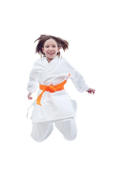 Jumping karate girl in kimono — Stock Photo, Image