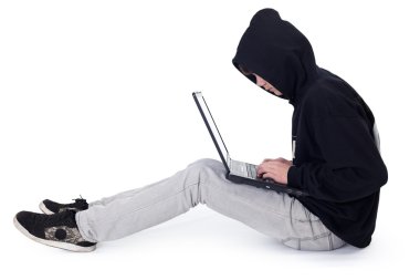 Teenager hacker with laptop