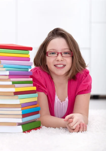 Young girl with lots of books Stock Photo