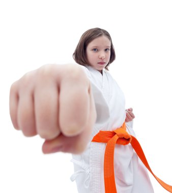 Karate girl with her fist in foreground clipart