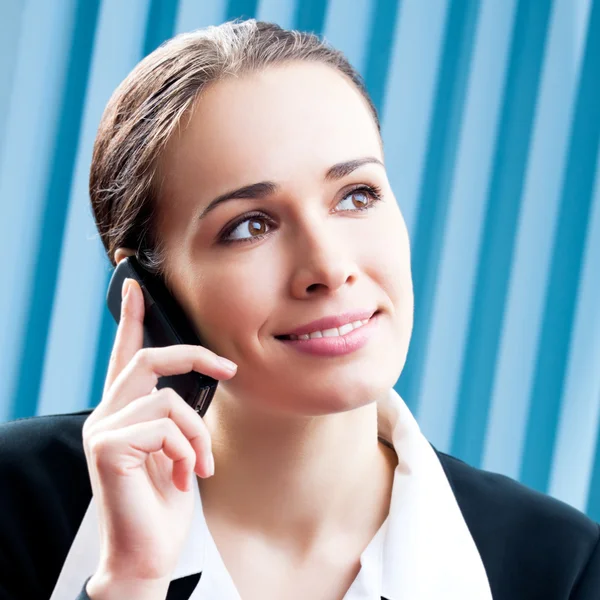 Businesswoman with cellphone at office — Stock Photo, Image