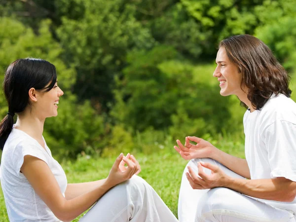 Young couple meditating together, outdoors — Stock Photo, Image