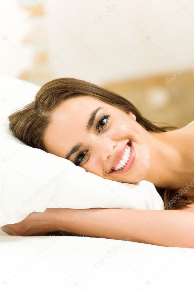 Happy woman waking up at home