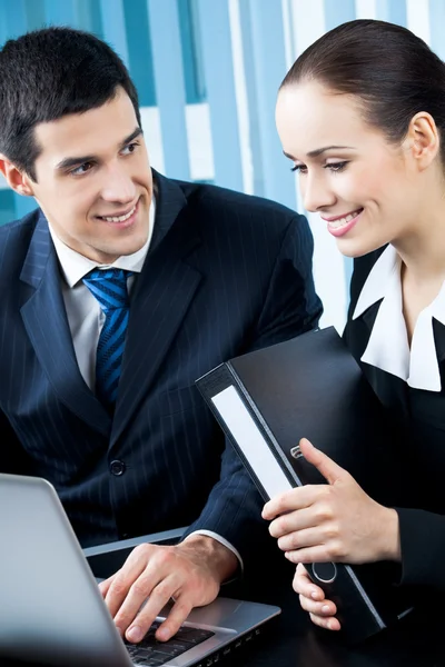 Two happy businesspeople working together at office Stock Picture