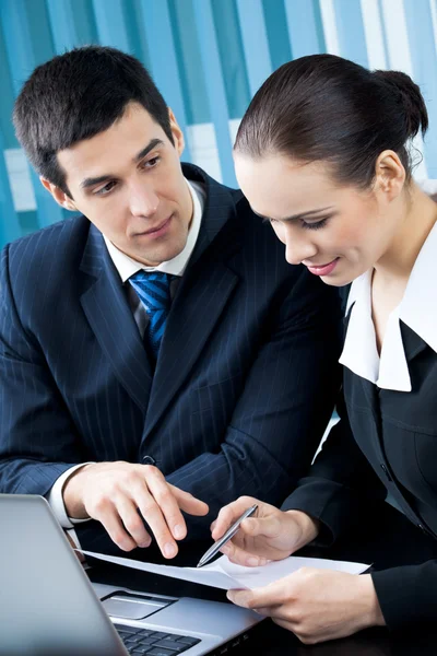 Two happy businesspeople working together at office Royalty Free Stock Images