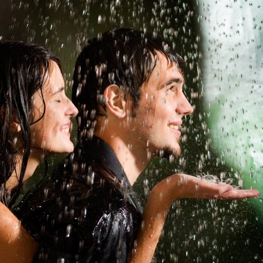 Young happy couple under a rain clipart