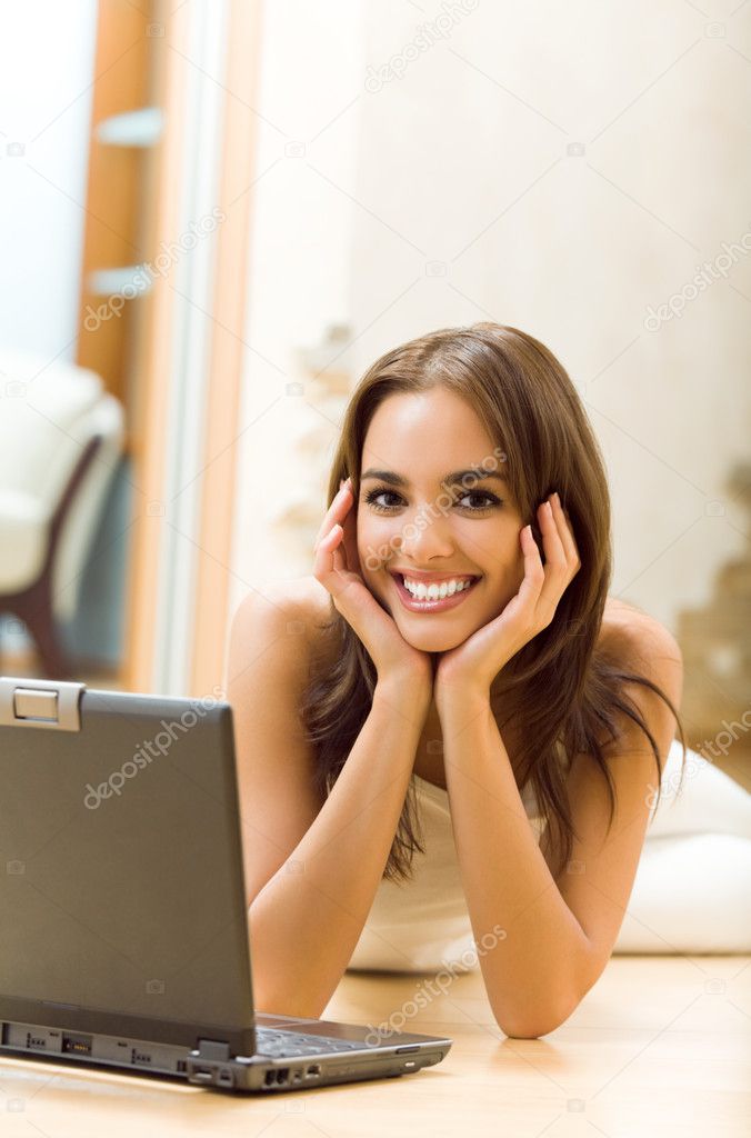 Woman working with laptop, at home