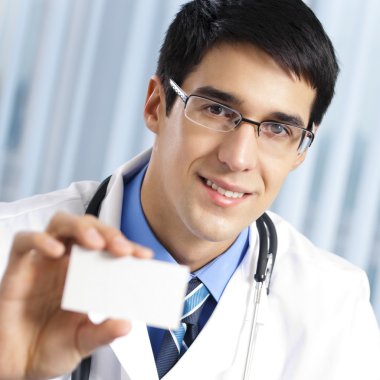 Doctor showing business card, at office clipart