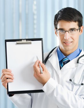 Doctor with clipboard at office clipart