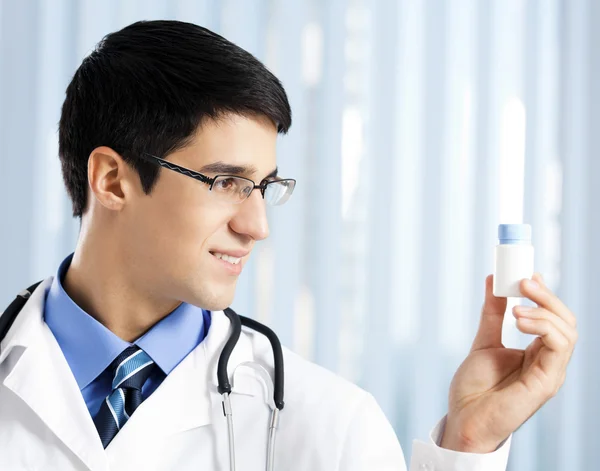 Felice medico mostrando bottiglia di farmaci — Foto Stock