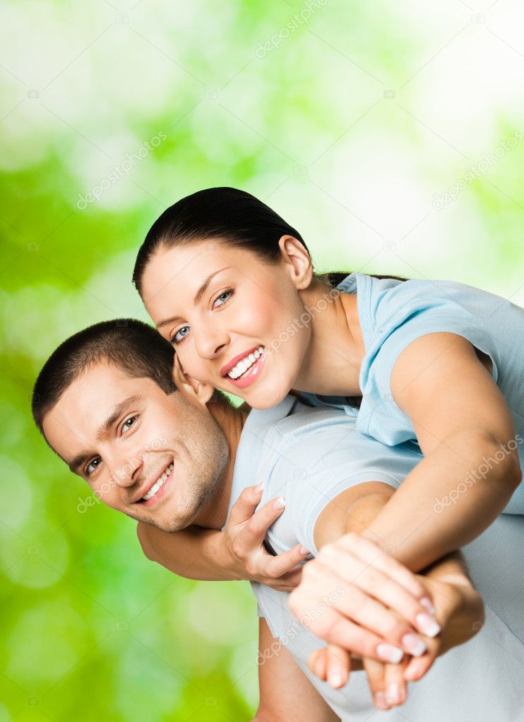 Portrait of young smiling couple, outdoors