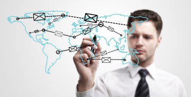 Young business man drawing a global network with envelopes on world map. clipart