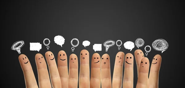 Happy group of finger smileys with social chat sign and speech bubbles. — Stock Photo, Image