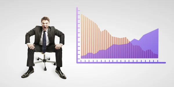 Young business man shouting and sitting on a chair with a graphs — Stock Photo, Image