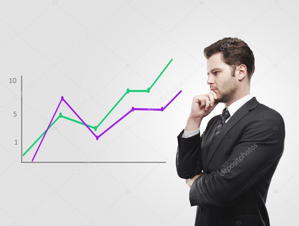 Young business man look at a graph
