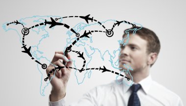 Young business man drawing an airplane routes on world map clipart