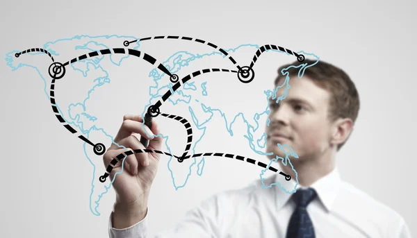 Young business man drawing a global network or globalization concept — Stock Photo, Image