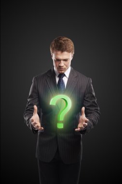 Young businessman with a question mark on his hands clipart