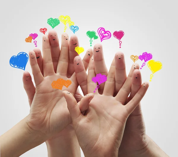 Group of happy finger smileys with love heart speech bubbles — Stock Photo, Image