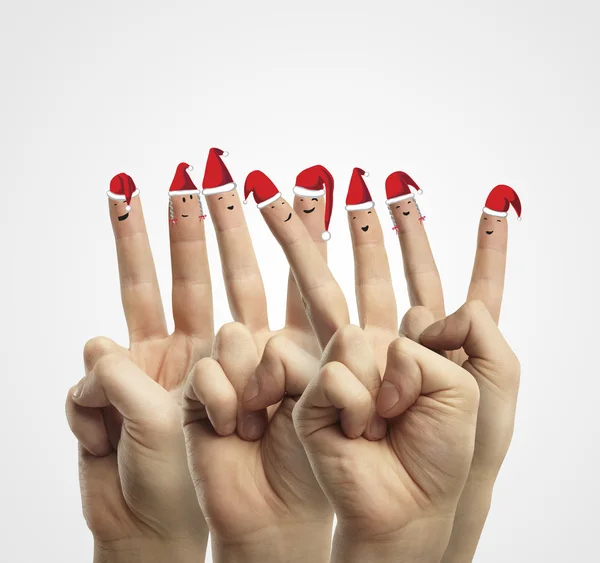 Fingers dressed in Santa-Claus red-white hats. — Stock Photo, Image