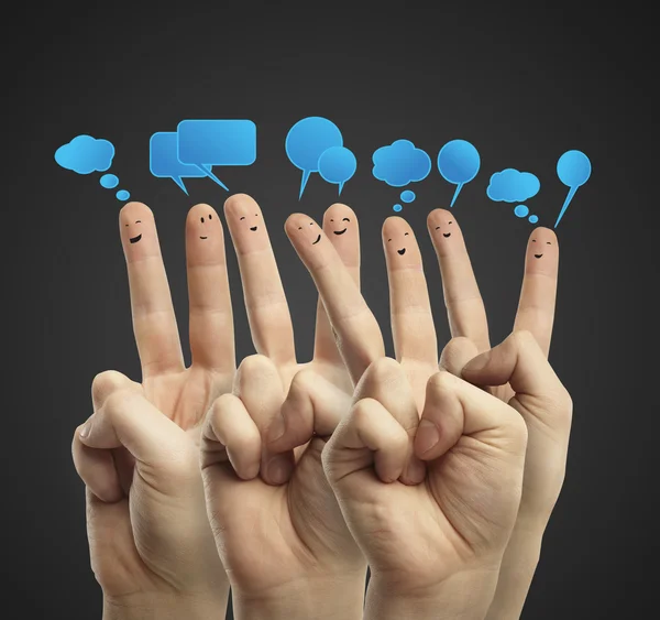 Happy group of finger smileys with social chat sign and speech bubbles — Stock Photo, Image