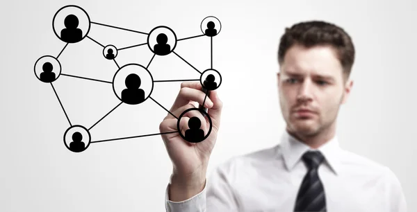 Young business man drawing a social network or globalization concept. — Stock Photo, Image