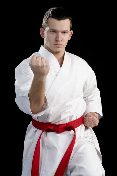 Contrast karate jonge vechter op zwart — Stockfoto