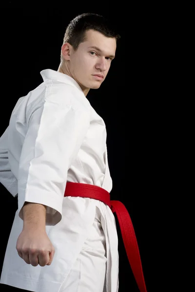 Kontrast karate ung fighter på svart — Stockfoto