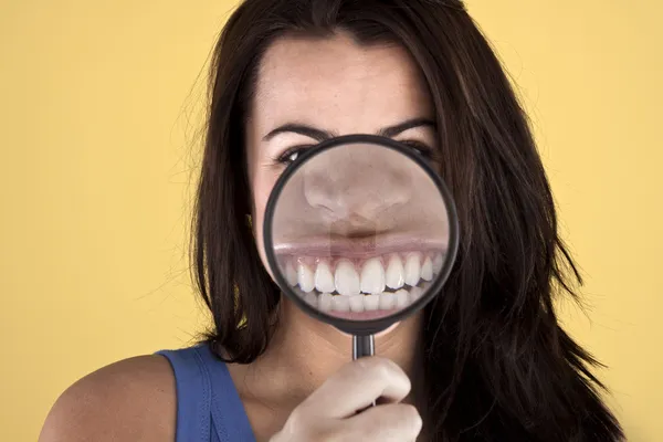 stock image Beautiful woman showing off her teeth.