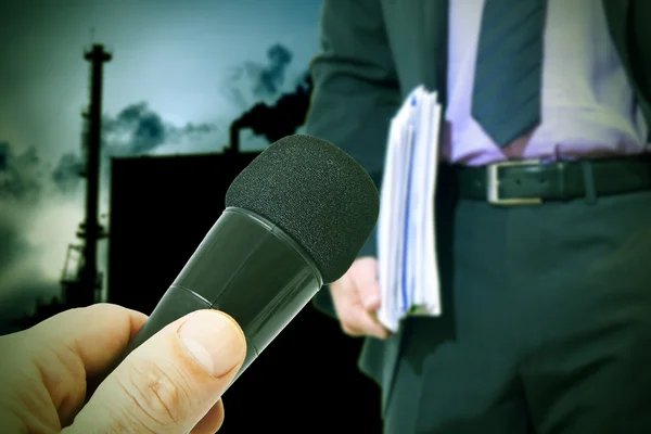 Pollution and businessman with microphone — Stock Photo, Image
