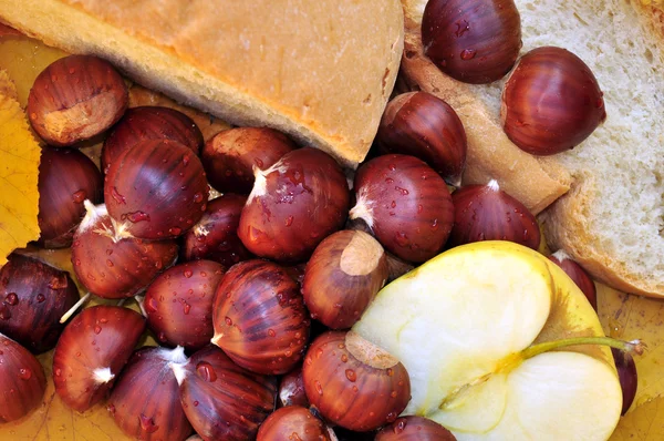 Still life with chestnuts, apple and bread — Stock Photo, Image
