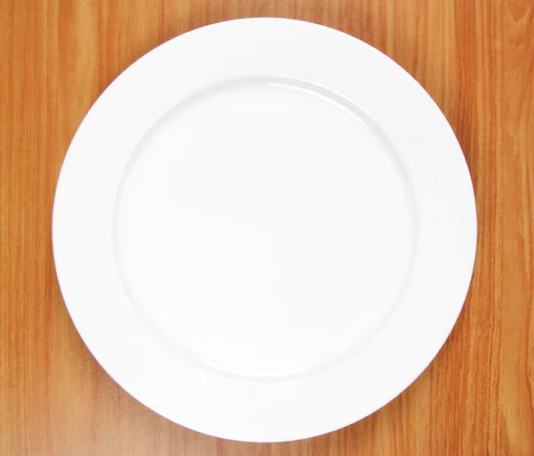 Empty plate on wood — Stock Photo, Image