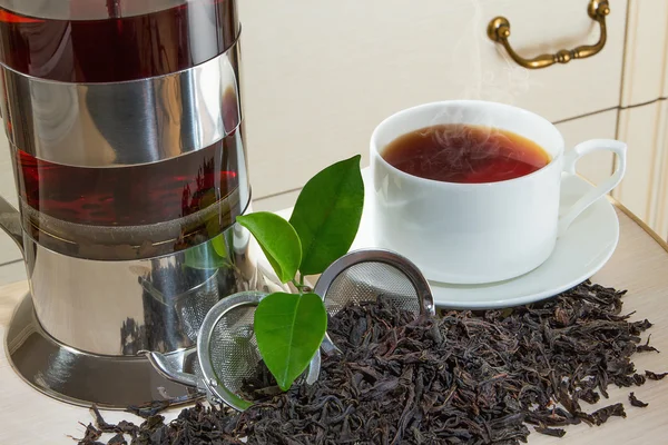 stock image Black iron asian teapot with sprigs of mint for tea