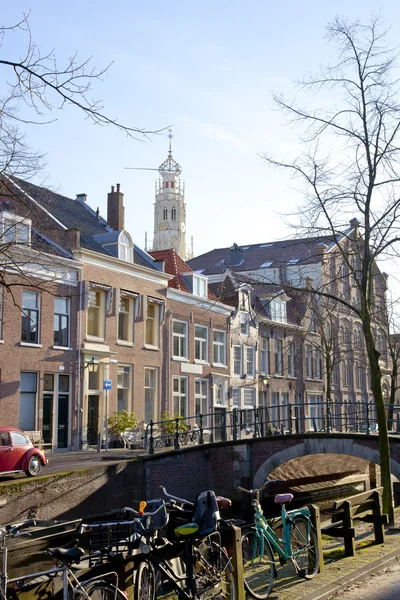 Dutch canal with old houses, church and bridge with blue sky — Stock Photo, Image