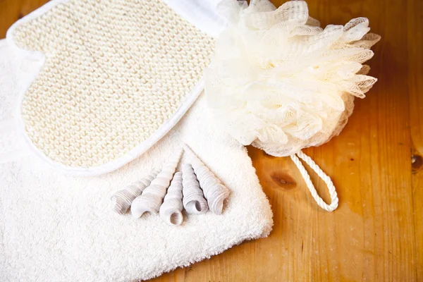 stock image Luxury bath or shower set with towel, glove and shells on wooden background