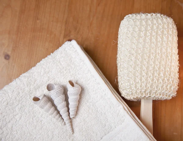 Set de baño o ducha de lujo con toalla, cepillo y conchas sobre fondo de madera —  Fotos de Stock