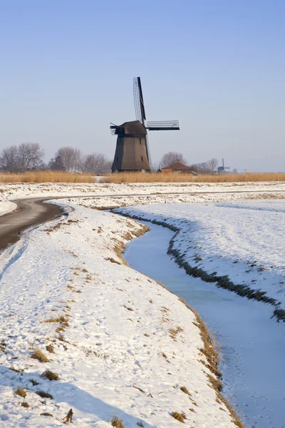 Windmill in winter time with snow, ice and blue sky — Stock Photo, Image