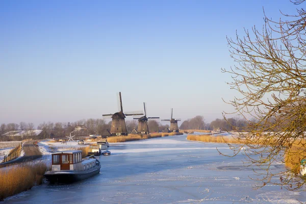 Windmill in winter time with snow and blue sky — Stock Photo, Image