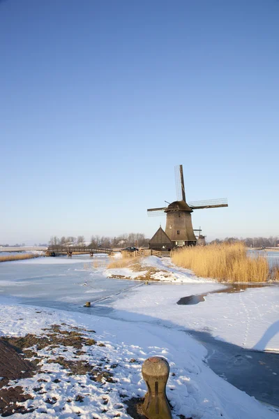Windmill in winter time with snow and blue sky — Stock Photo, Image