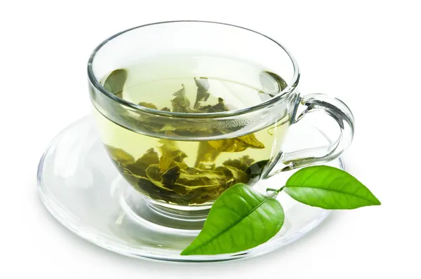 Cup with green tea and green leaves. — Stock Photo, Image