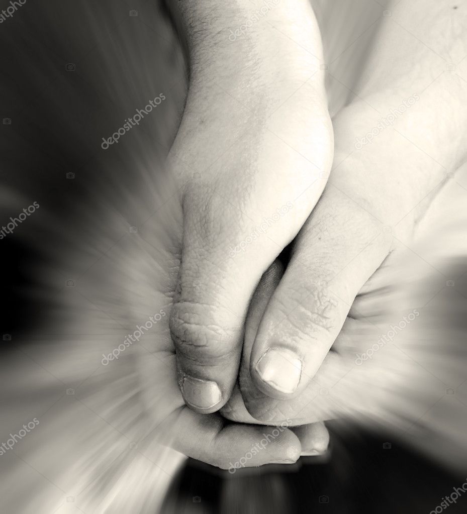 Children's hands holding rays of shining light.
